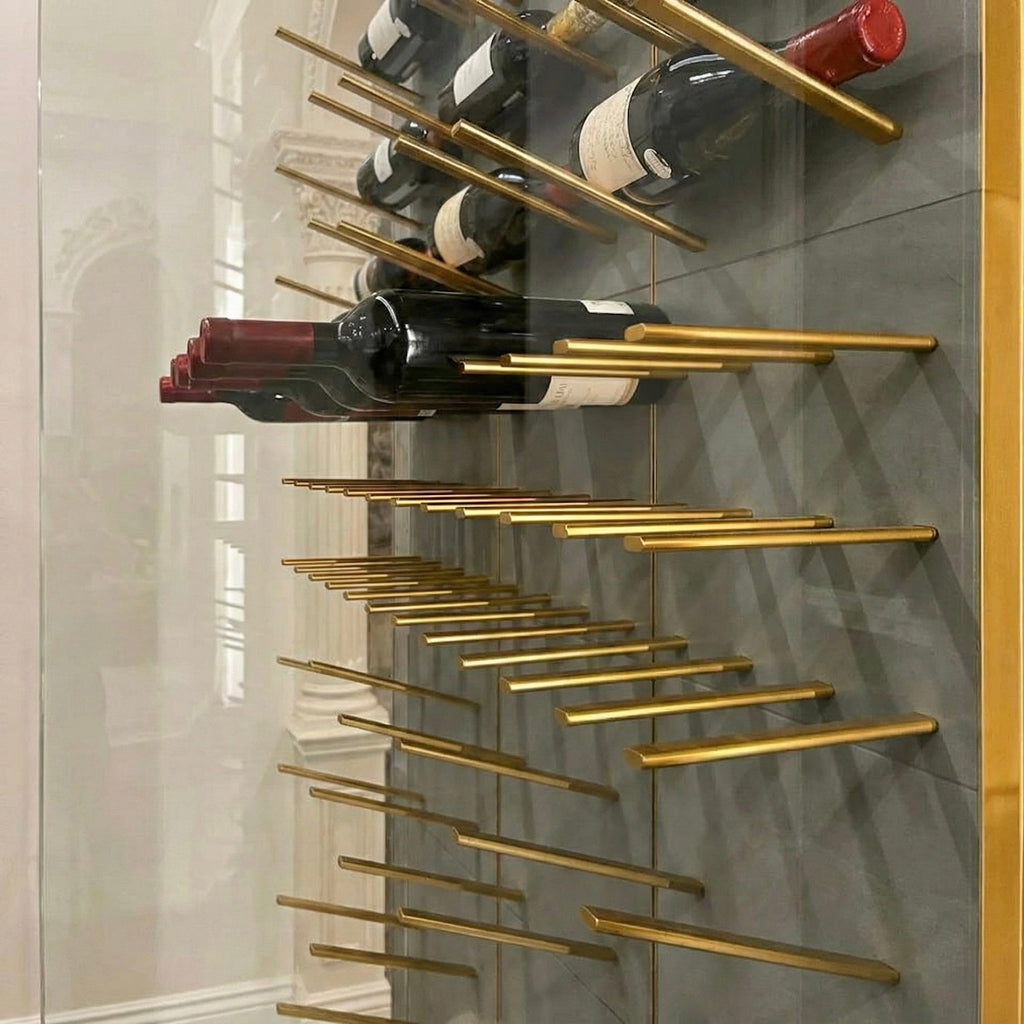 stact premier wine racks with gold metal hardware create an opulent design feature within a glass enclosed wine cellar.