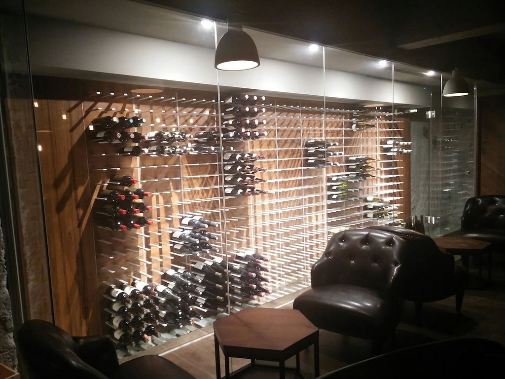 commercial wine tasting room with a large feature wall wine display enclosed in glass