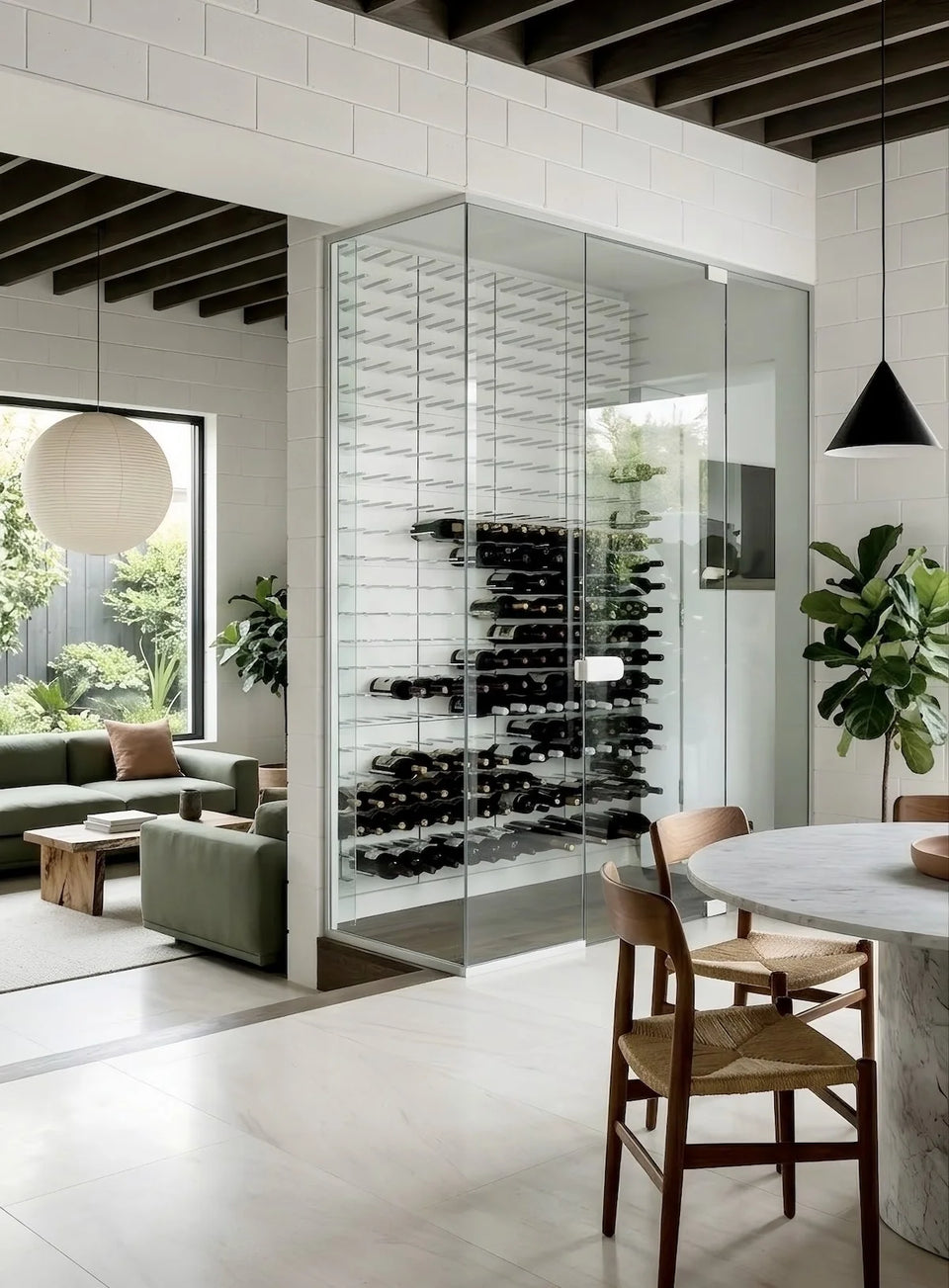 Modern interior with a wine rack in a glass wall, living area, and dining table.