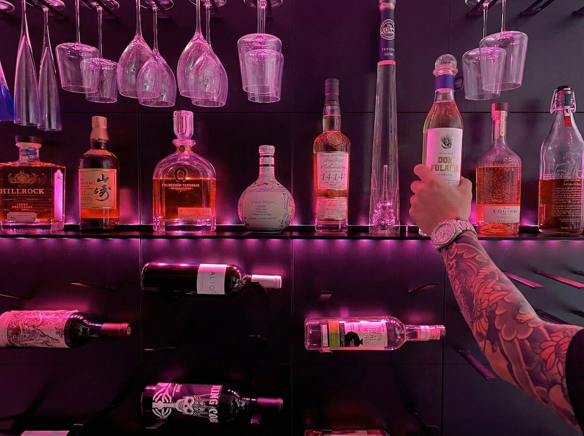 STACT Premier BlackOut wine and liquor display with integrated wall-mounted shelving for bottles, spirits and barware.