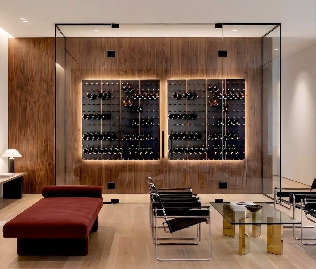 Modern living room with a glass-enclosed wine wall, wood paneling, backlit wall-mounted wine racks, and contemporary lounge seating.