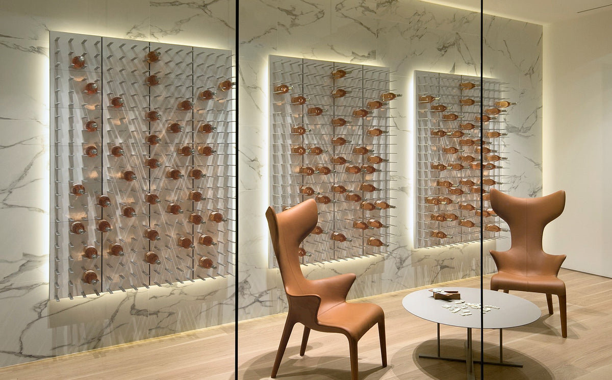 Glass-enclosed tasting room with STACT Premier White & Silver C-type wine racks set against marble.