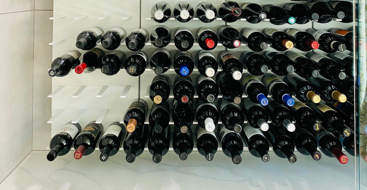 STACT Premier WhiteOut C-type wine racks in a bright peg-and-panel wine cellar installation.