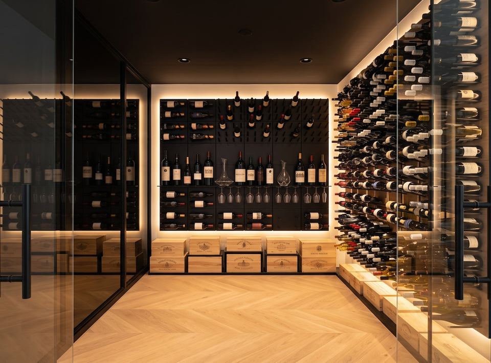 STACT Premier modular wine display panels with integrated bottle storage and stemware, featured in a contemporary glass-enclosed wine cellar.