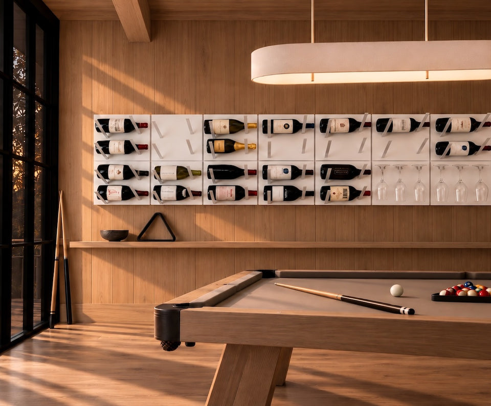 STACT Premier modular wine display in White & Silver, featuring label-out wine racks and integrated stemware racks above a pool table in a modern oak-paneled billiards room.