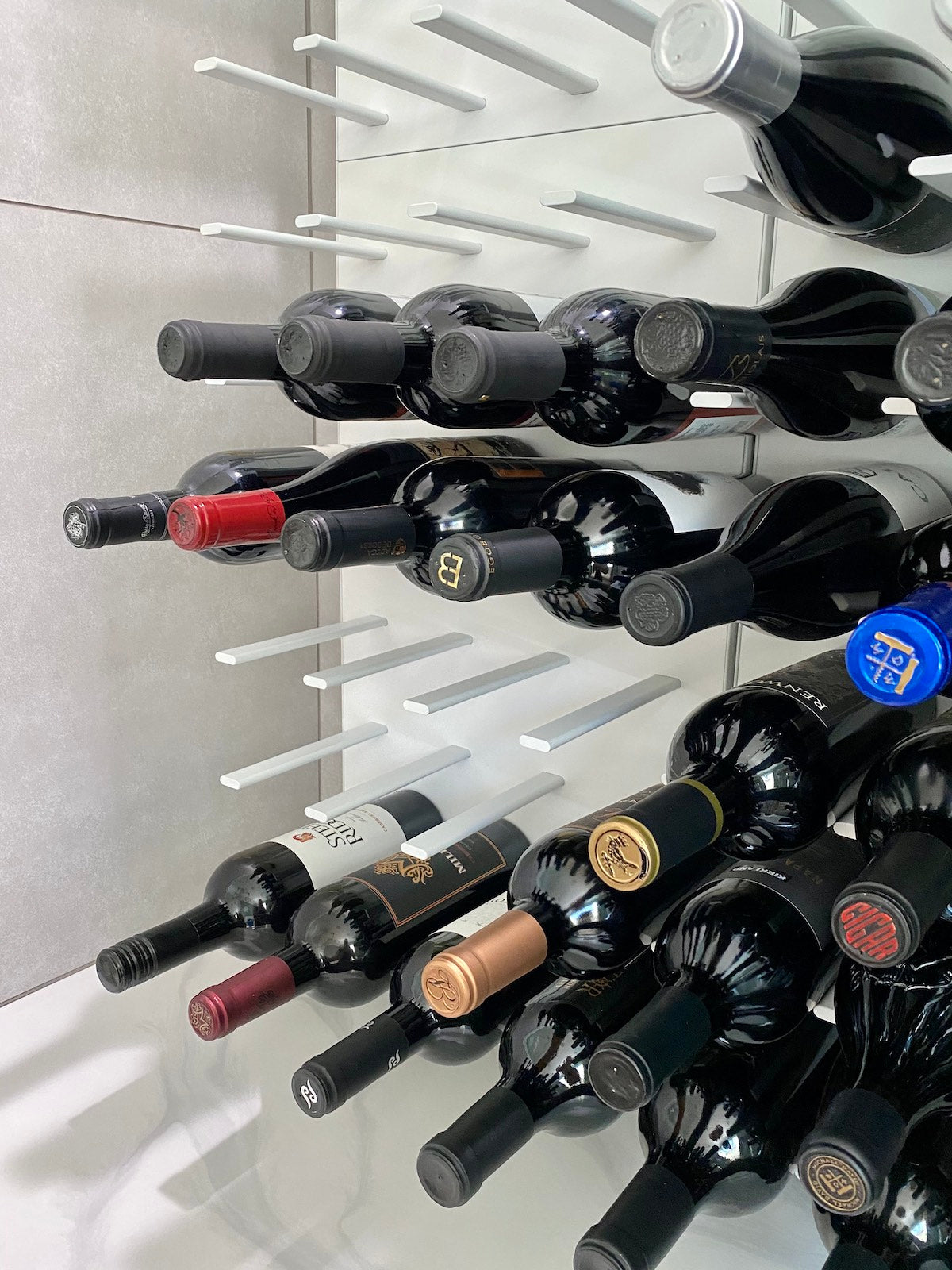 Modern California wine cellar with STACT Premier WhiteOut C-type wall-mounted wine racks.